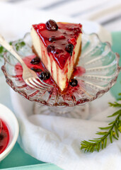 Classic New York cheesecake portion   on vintage glass stand. Closeup view. Selective Focus.