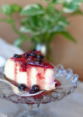 Classic New York cheesecake portion   on vintage glass stand. Closeup. Selective Focus.