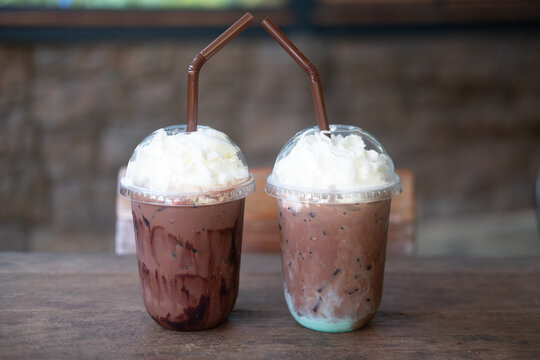 Iced mint chocolate drink and iced chocolate drink in plastic glass