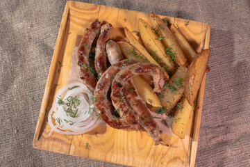 Delicious Provencal sausages with rustic potatoes and onions