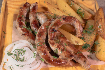 Delicious Provencal sausages with rustic potatoes and onions