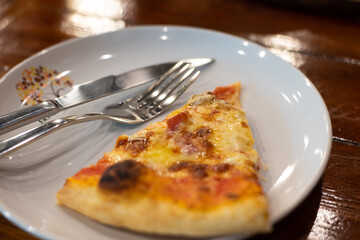 Close up pizza on woodden plate.