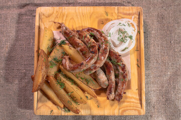 Delicious Provencal sausages with rustic potatoes and onions