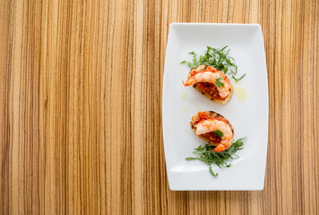 Shrimps on bruschette and design