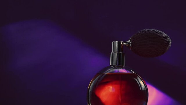 Vintage perfume bottle and shining light flares on dark background, glamorous fragrance scent as luxury perfumery product for cosmetic and beauty brand, stock footage