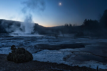 Moonrise at dawn over Mammoth Hot Springs;  Yellowstone NP;  Wyoming