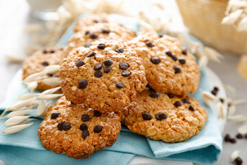 Homemade oatmeal cookies with chocolate drops and milk for breakfast.