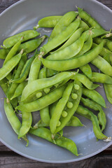 Young, green peas on a twig and on a Board close-up