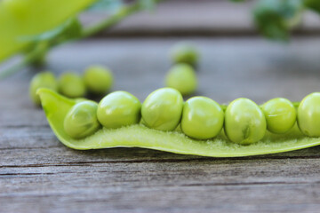 Young, green peas on a twig and on a Board close-up