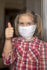 Portrait of a female child wearing a protective medical face mask - covid-19 prevention concept