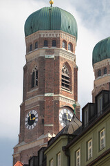 Fototapeta na wymiar Both onion domes of the Gothic cathedral and city parish church known as the Frauenkirche, Dom zu unserer Lieben Frau, Cathedral of Our Dear Lady, travel destination backgrounds at Munich Germany