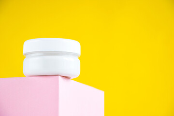 White glass jar on a yellow background with space for your text. Creative layout.