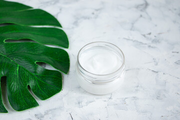 Empty white tubes for cosmetic products lie on a light concrete background. Creative layout copy space for text.