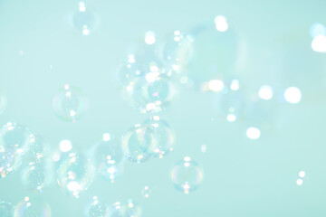 Beautiful blurry bokeh clear soap bubbles background.