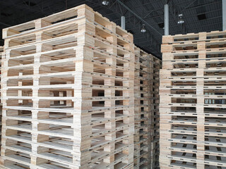 Stack of wooden pallets at industrial warehousing.