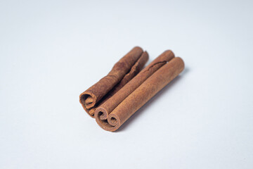 Cinnamon on a white background. Two cinnamon sticks, one next to the other.