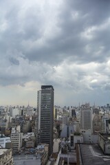 Vertical high angle shot of buildings in a city under the cloudy sky in Brazil