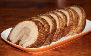 Close-up crispy shashu (Chashu) pork roll on plate.