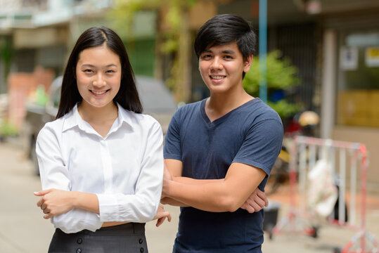 Portrait of young Asian couple together outdoors