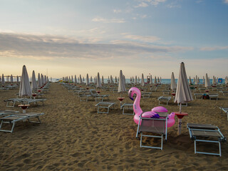 Pink inflatable mattress Flamingo on the beach close-up. Summer and holiday concept.