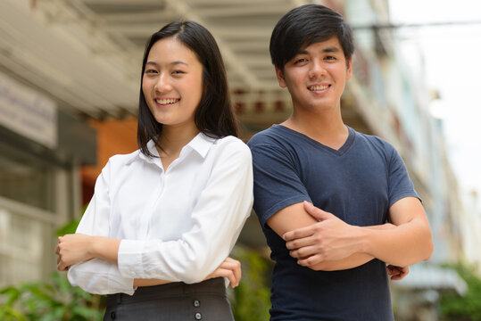 Portrait of young Asian couple together outdoors