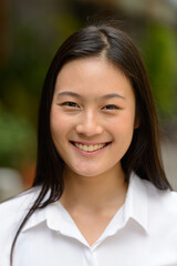 Portrait of young beautiful Asian businesswoman outdoors