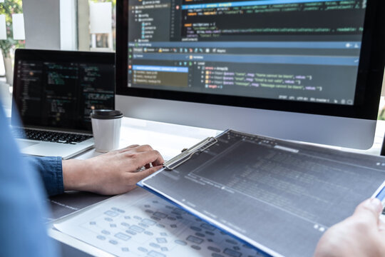 Developer programmer working on project in software development computer in IT company office, Writing codes and data code website and coding database technologies to find solution to problem