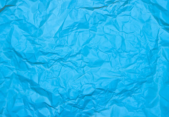 Crumpled blue background. Wrinkled blue texture.