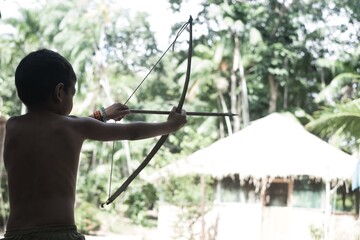 MANAUS, BRAZIL - Feb 23, 2019: Young Indigenous with a Bow