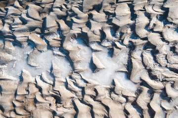 Mud texture with waves. Healing mud in nature. Salt background.