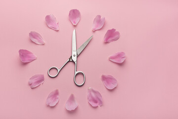 Obraz na płótnie Canvas Dial of flowers. Scissors and flower petals on pink background.