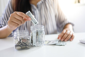 Fototapeta premium Saving money concept Financial woman hand stack coins money banknotes growing business. Saving money