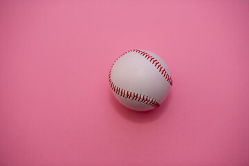 Baseball isolated against pink background with ample copy space.