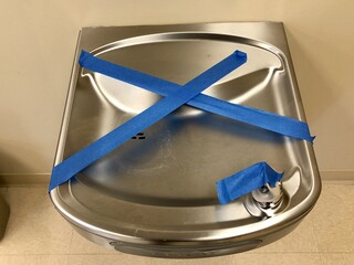 Closeup shot of public drinking fountain closed due to spread of covid19