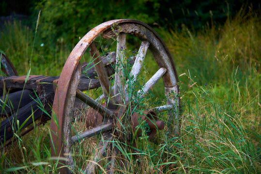an old wooden wheel in the grass