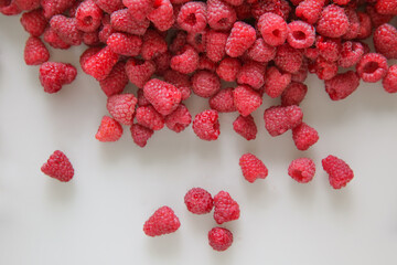 a lot of raspberries on a white background, close-up, red, ripe, free space, place for an inscription	

