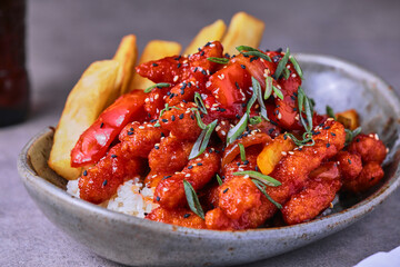 Sweet and Sour Chicken with rice and fries.