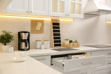 Stylish kitchen interior with modern coffeemaker on countertop