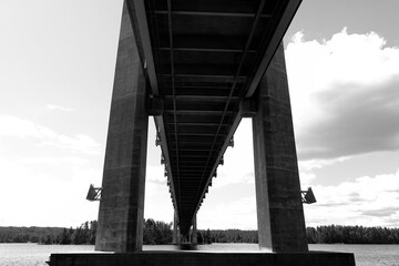 Under the long bridge. Black and white image.