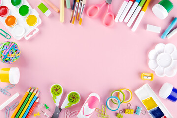 Various school office and painting supplies on pink background. Back to school concept. Top view. Copy space