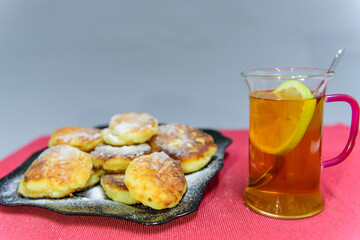 Homemade sweet curd cakes fried in oil, decorated with powdered sugar. Russian kitchen.