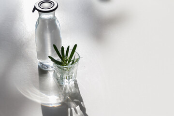 The Glass of water with a bottle on table
