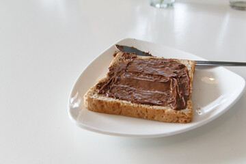 Bread with chocolate cream on the table