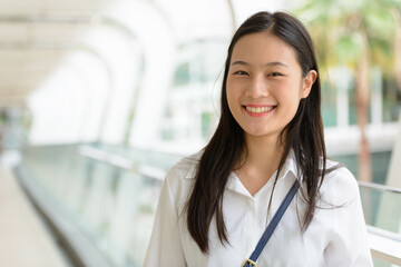 Young beautiful Asian businesswoman at the footbridge