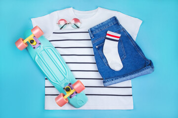 Sport inspired flatlay with turquoise penny skateboard