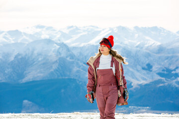 Beautiful asian woman enjoying and relaxing view with snow flake on snow mountain during winter in New Zealand.