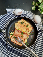 Bread Omelette Sandwich topped with fresh chili flakes, oregano & herbs on a plate.