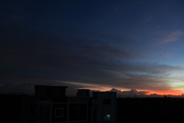 Sunset sky with beautiful clouds with a botanical garden in the backdrop.