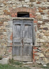 The medieval-style wooden door in Tuscany Italy