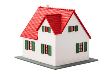 Miniature house isolated on a white background with clipping path. Real estate family home for sale.